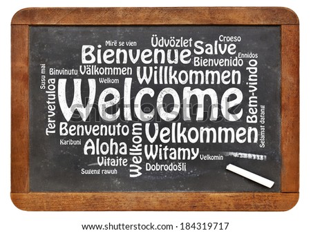 Welcome in different languages - a word cloud in white chalk text on a vintage slate blackboard isolated on white