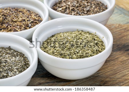 bowls of seaweed diet supplements (bladderwrack, sea lettuce, kelp, wakame and Irish moss), focus on sea lettuce