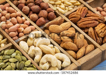 nuts and seed collection (cashew, pecan, hazelnut,pine nuts, peanut, pumpkin) in an old typesetter wooden drawer