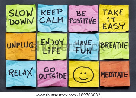 slow down, relax, take it easy, keep calm and other motivational  lifestyle reminders on colorful sticky notes