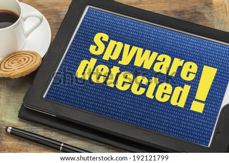 spyware  detected alert on a digital tablet with a cup of coffee