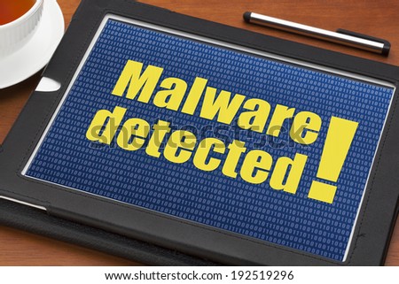 malware detected alert on a digital tablet with a cup of tea