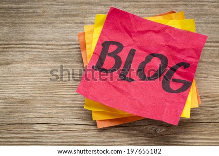 blog word on a sticky note against grained wood