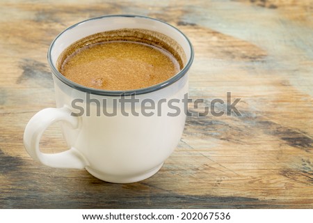 cup of fresh fatty coffee with butter and coconut oil - ketogenic diet concept