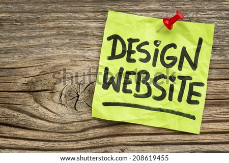 design website  reminder - handwriting on a green sticky note against grained and knotted wood board