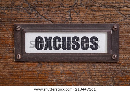 excuses  - file cabinet label, bronze holder against grunge and scratched wood