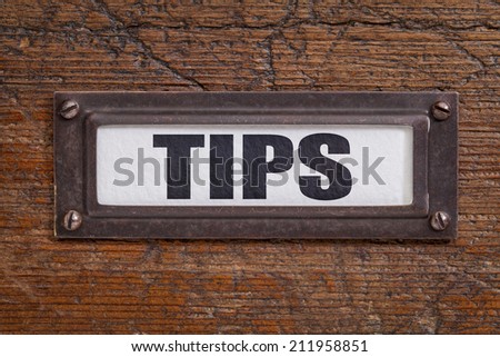 tips  - file cabinet label, bronze holder against grunge and scratched wood