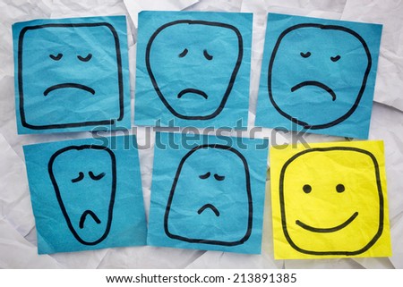 a set of sad, unhappy and happy, faces - rough sketches on isolated blue and yellow sticky notes