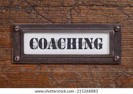 coaching  - file cabinet label, bronze holder against grunge and scratched wood