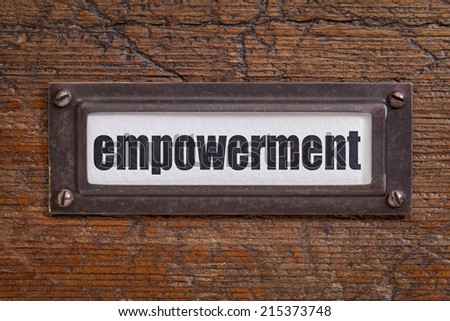 empowerment - file cabinet label, bronze holder against grunge and scratched wood