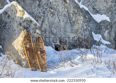 winter landscape with  sandstone rocks and classic Bear Paw snowshoes