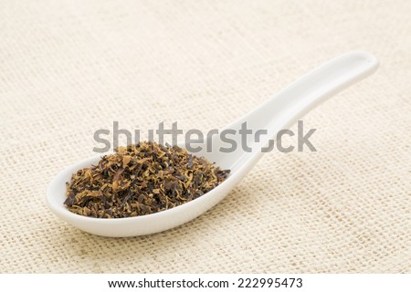 Irish moss seaweed on a white Chinese spoon against burlap canvas