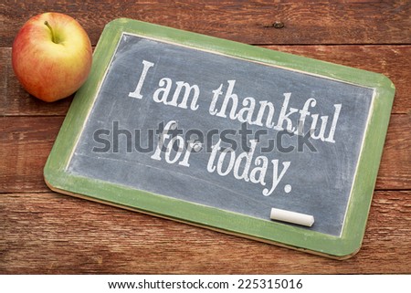 I am thankful for today - positive words on a slate blackboard against red barn wood