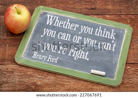 Whether you think you can or you can\'t - you\'re right, motivational quote by Henry Ford on a slate blackboard against red barn wood