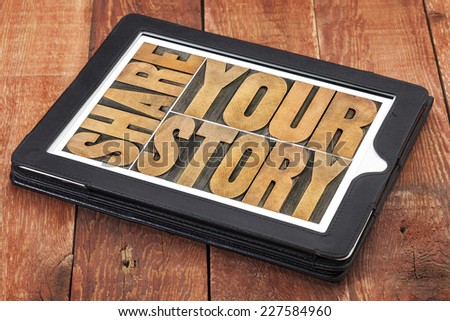 share your story word abstract  - isolated text in vintage letterpress wood type on a digital tablet against rustic red barn wood