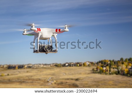 FORT COLLINS, CO, USA, October 17, 2014:  Radio controlled Phantom quadcopter drone flying over foothills with a Panasonic Lumix GM1 camera mounted on a home made platform.
