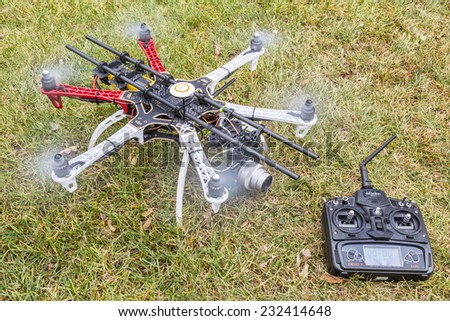 FORT COLLINS, CO, USA, November 22,  2014: DJI  F550 Flame Wheel  hexacopter drone, assembled from a kit, ready for aerial photography mission, shown with spinning rotors and Devo 7 transmiter.