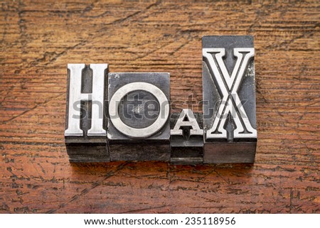 hoax word in mixed vintage metal type printing blocks over grunge wood