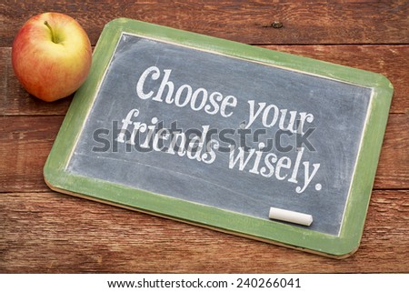 choose your friends wisely - advice on a slate blackboard against red barn wood