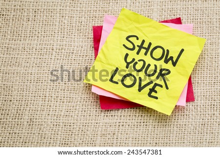 show your love   - advice or reminder on a sticky note against burlap canvas