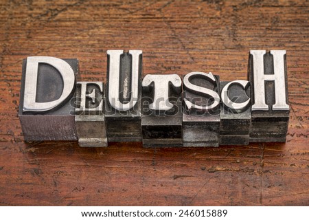 Deutsch (German) word in mixed vintage metal type printing blocks over grunge wood