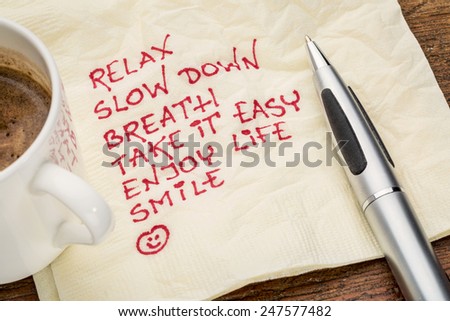 stress reduction concept - relax, slow down, breath, take it easy, enjoy life, smile handwriting on a napkin with a cup of coffee