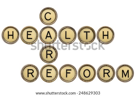 health care reform crossword in old round typewriter keys isolated on white