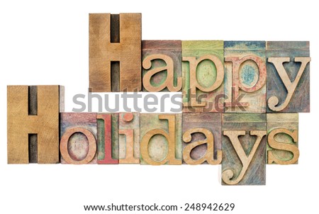 Happy Holidays - isolated text in letterpress wood type printing blocks stained by color inks