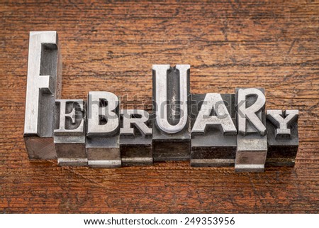 February word in mixed vintage metal type printing blocks over grunge wood