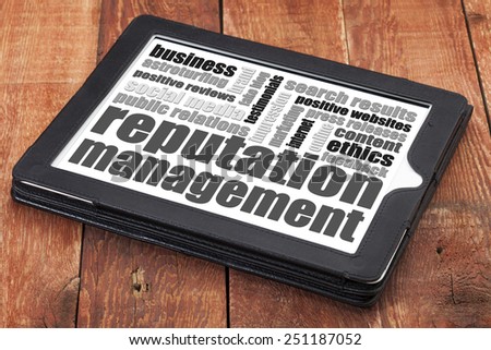 reputation management word cloud on a digital tablet tablet against red wood