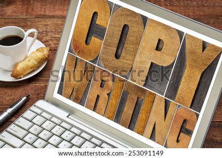 copywriting word in letterpress wood type printing blocks on a laptop with cup of coffee
