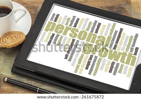 personal growth word cloud on a digital tablet with a cup of coffee