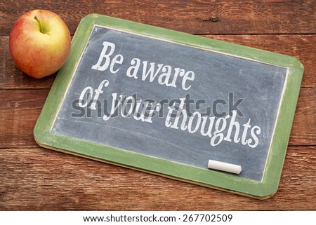 Be aware of your thoughts - inspirational  words on a slate blackboard against red barn wood