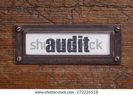 audit  - file cabinet label, bronze holder against grunge and scratched wood