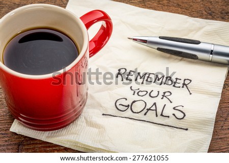 remember your goals - handwriting on a napkin with a cup of epsresso coffee