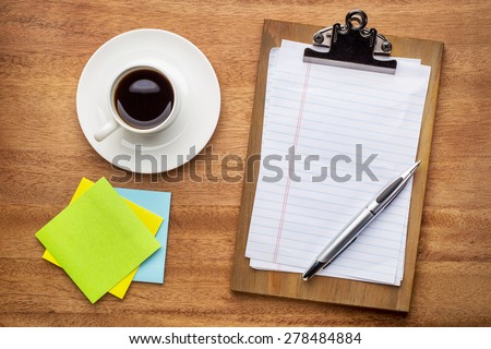 desktop concept - clippboard with blank paper and pen, sticky notes and coffee