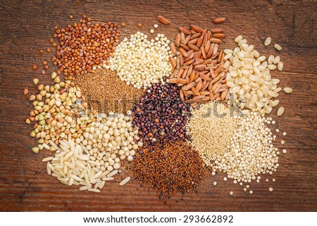 gluten free grains (buckwheat, amaranth, brown rice, millet, sorghum, teff,  red, black and white quinoa)  on rustic wood - top view