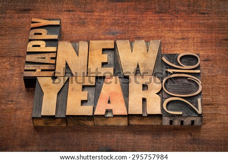 Happy New Year 2016 greetings  - word abstract in vintage letterpress wood type blocks on a grunge wooden background