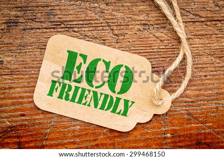 eco friendly  sign a paper price tag against rustic red painted barn wood - shopping concept