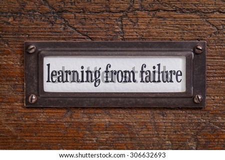 learning from failure -  a label on a grunge wooden file cabinet
