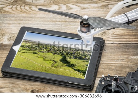 drone aerial photography concept - reviewing aerial picture of Colorado foothills near Fort Collins  on a digital tablet with a drone rotor and radio control transmitter,