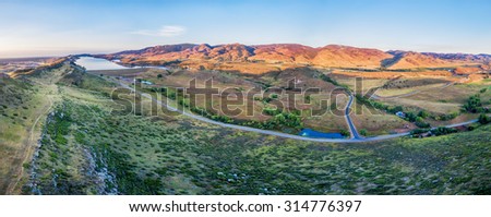 aerial panorama of foothills near Fort Collins, Colorado with Horsetooth Reservoir, Lory State Park, Charles Hansen Canal and Centennial Road, sunrise at late summer