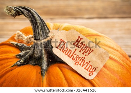 pumpkin with a Happy Thanksgiving paper price tag -  holiday shopping concept