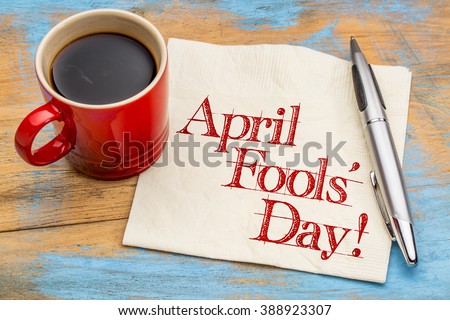 April Fools\' Day! Handwriting on a napkin with a cup of coffee