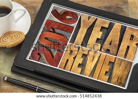 2016 review banner - annual review or summary of the recent year - word abstract in vintage letterpress wood type blocks on a digital tablet with coffee