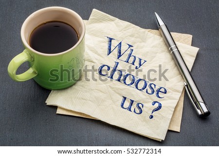 Why choose us? Handwriting on a napkin with cup of coffee against gray slate stone background