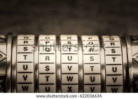 trust word as a password to combination puzzle box with rings of letters, black and white platinum toned image