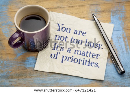 You are not too busy, it is a matter of priorities - handwriting on a napkin with a cup of espresso coffee
