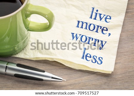 live more, worry less text - inspirational handwriting on a napkin with a cup of coffee