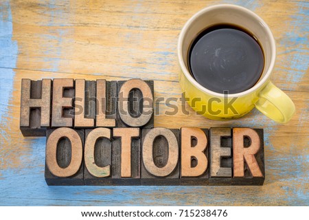hello October greeting card - vintage letterpress wood type blocks against grained wood with a cup of coffee